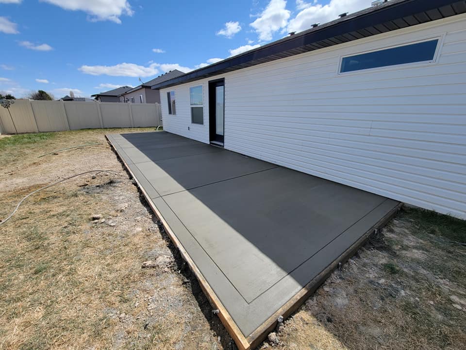 Smooth-finished concrete patio along home exterior