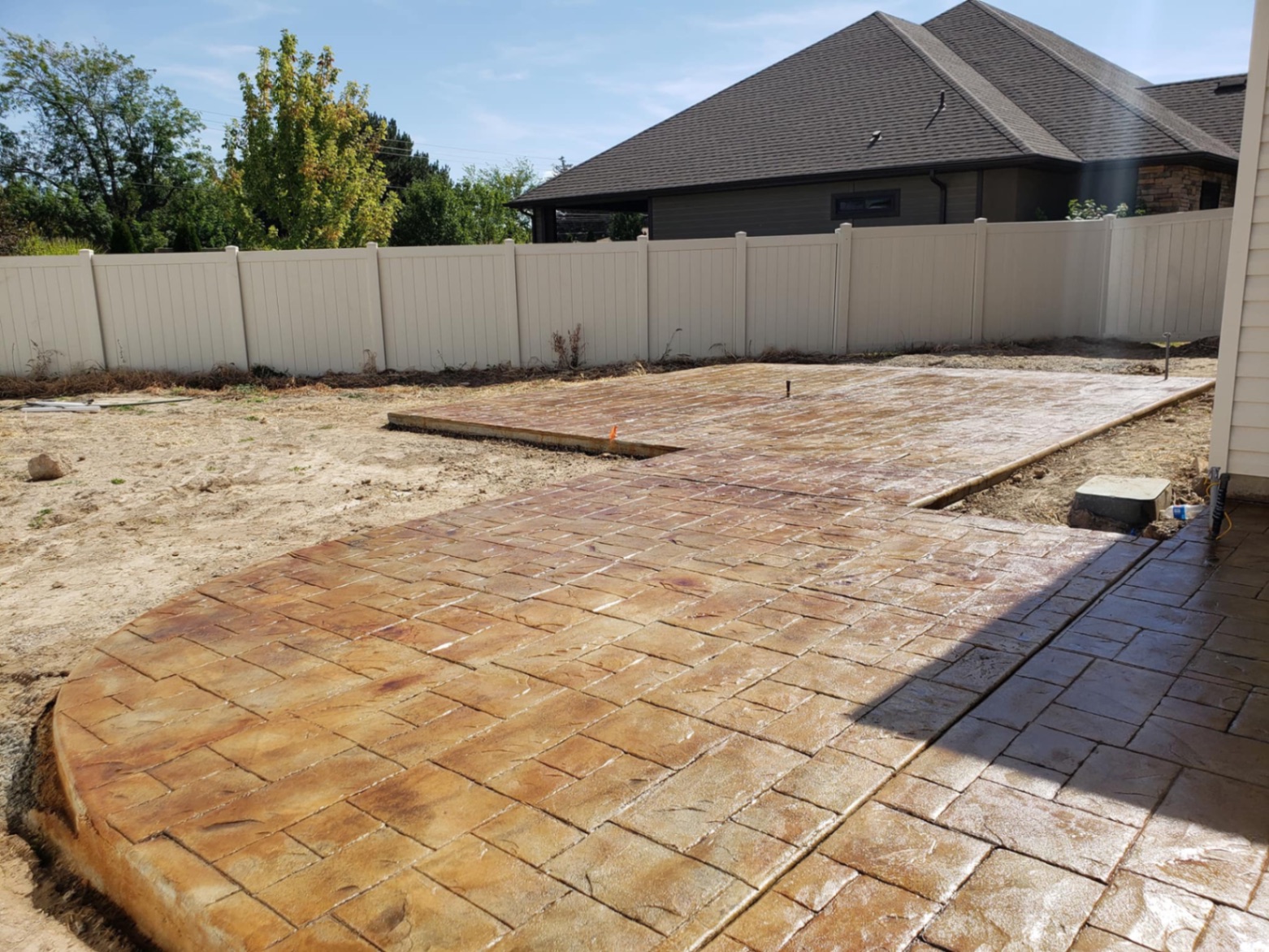 Stamped concrete walkway and patio with earth-tone stain