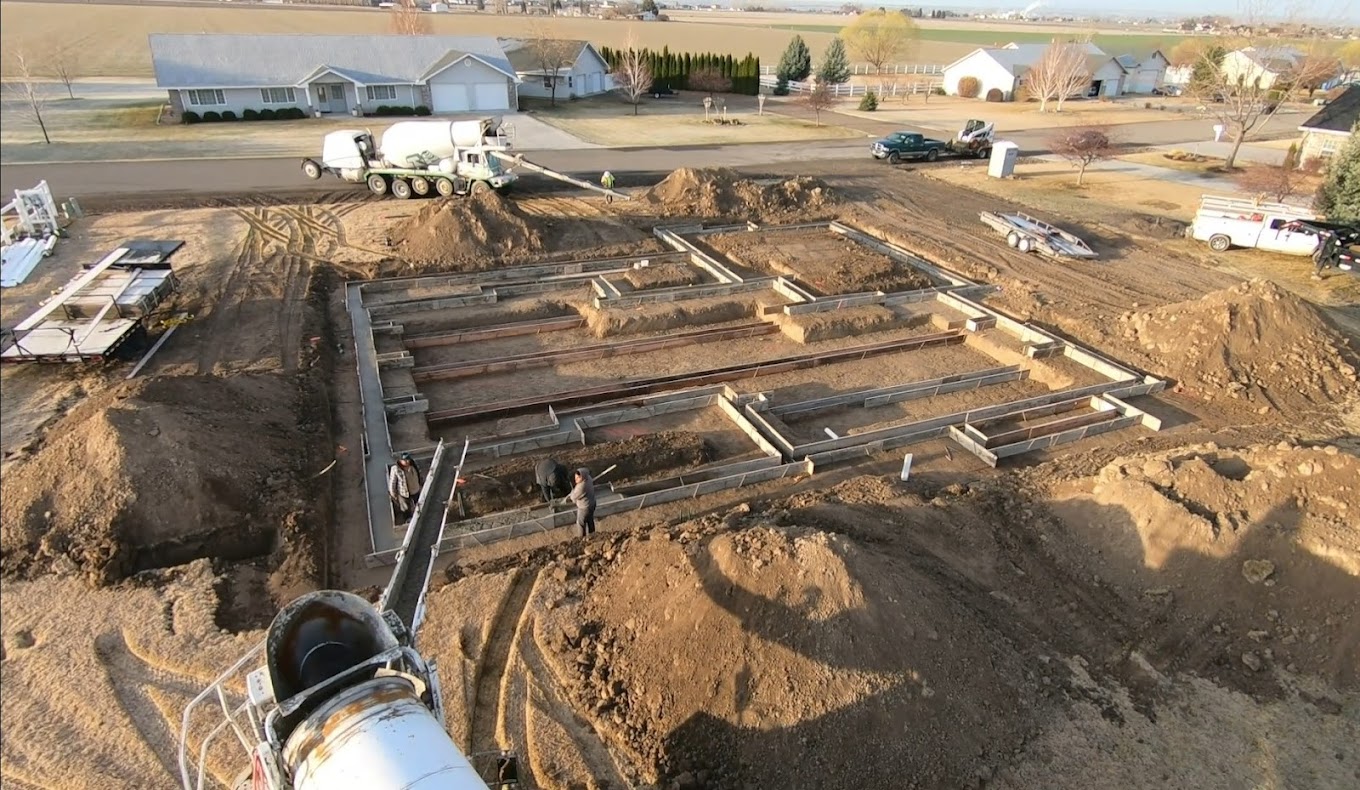 Custom home foundation pour with concrete truck on site